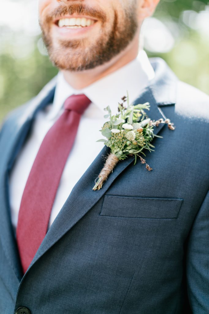 Parque at Ridley Creek Wedding | Philadelphia | Groom's bespoke boutonniere with textural seasonal greenery and no flowers, wrapped in earthy twine | Photo by Emily Wren Photography | Flowers by Love 'n Fresh Flowers