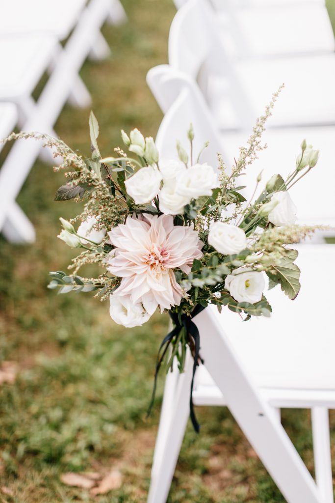 Parque at Ridley Creek Wedding | Philadelphia | Dahlias, lisianthus and other seasonal flowers tied to the chairs along the aisle at the ceremony | Photo by Emily Wren Photography | Flowers by Love 'n Fresh Flowers
