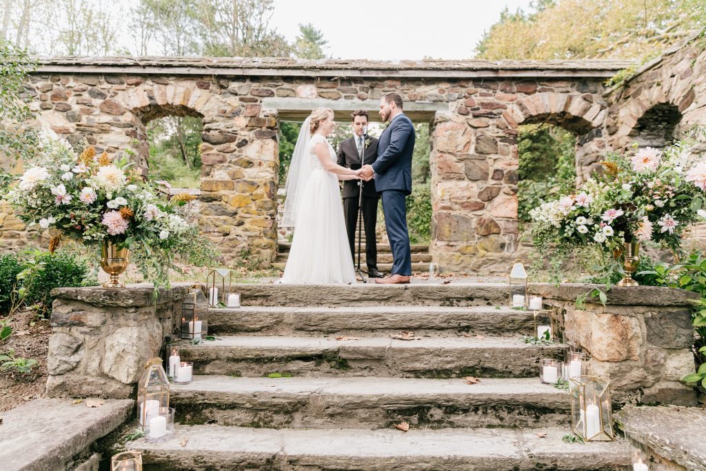 Parque at Ridley Creek Wedding | Philadelphia | Ceremony vows on the steps in the garden, framed by large lush floral urns and lanterns | Photo by Emily Wren Photography | Flowers by Love 'n Fresh Flowers