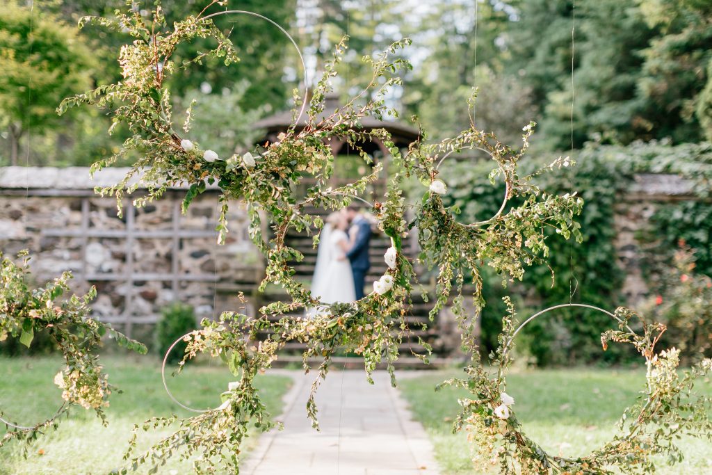 Parque at Ridley Creek Wedding | Philadelphia | Floral hoops hung as the ceremony backdrop created beautiful photos afterwards | Photo by Emily Wren Photography | Flowers by Love 'n Fresh Flowers