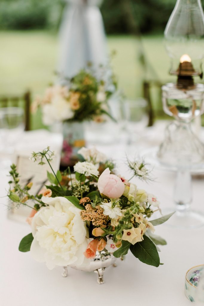 Spring Wedding at the Inn at Barley Sheaf in New Hope PA || Romantic seasonal flowers designed in vintage vases for the wedding reception centerpieces, including peonies, foxglove, yarrow, phlox, nigella and more in a white, peach and sage green palette. || Florals by Love 'n Fresh Flowers in Philadelphia || Photo by Lev Kuperman