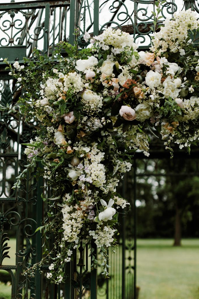 Spring Wedding at the Inn at Barley Sheaf in New Hope PA || Lush seasonal flowers adorning the wrought iron gazebo for the garden ceremony || Florals by Love 'n Fresh Flowers in Philadelphia || Photo by Lev Kuperman