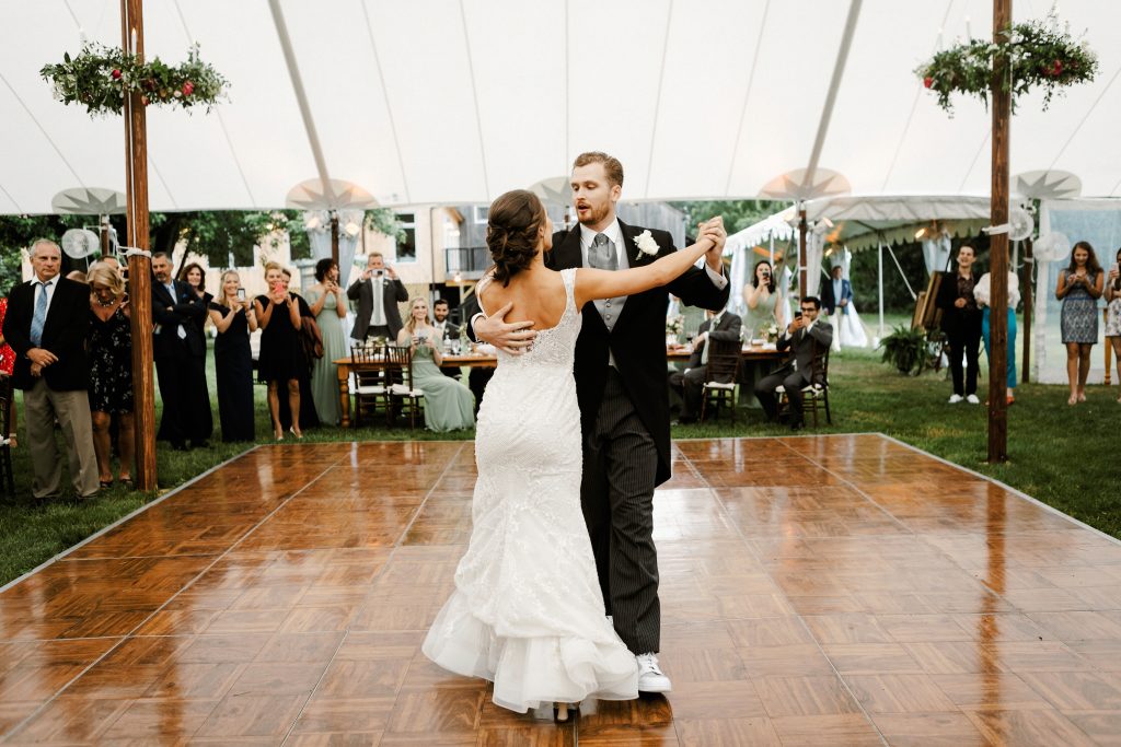 Spring Wedding at the Inn at Barley Sheaf in New Hope PA ||Callee and Skye danced under the floral hoops / floral chandeliers hung around the posts in the sailcloth tent for their wedding reception || Florals by Love 'n Fresh Flowers || Photo by Lev Kuperman