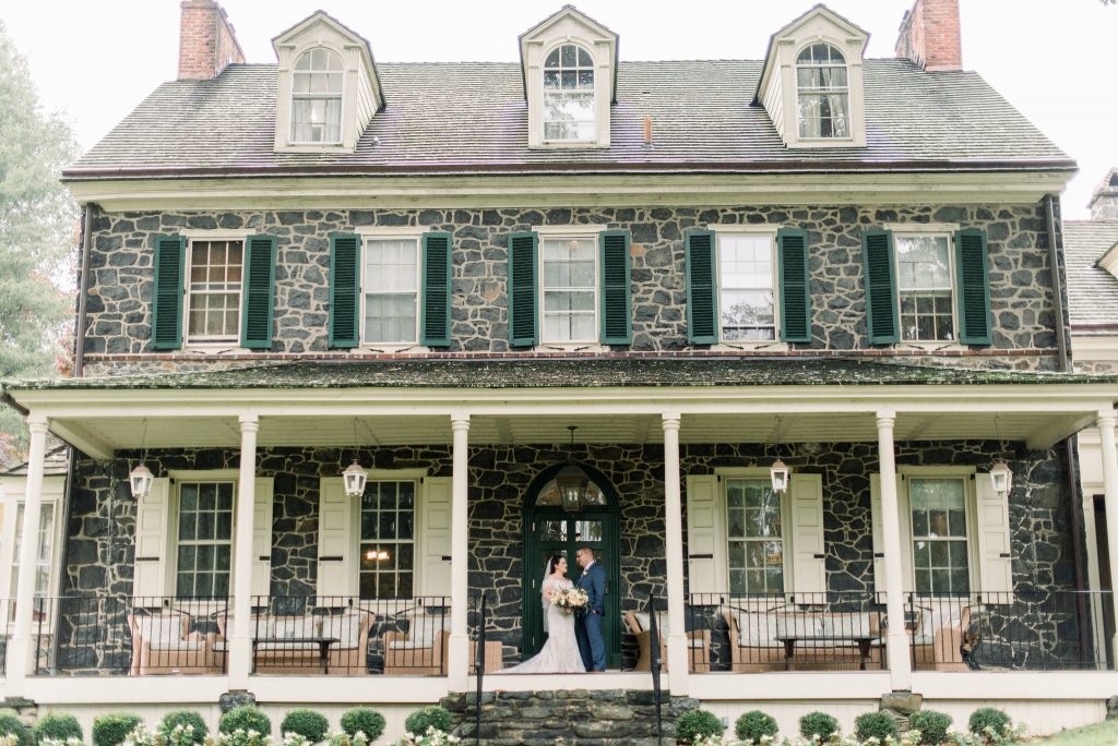 Inn at Grace Winery Wedding | Philadelphia | The front porch of the Inn makes a great location for bridal portraits even on a rainy day | Flowers by Love 'n Fresh Flowers | Photo by Hillary Muelleck