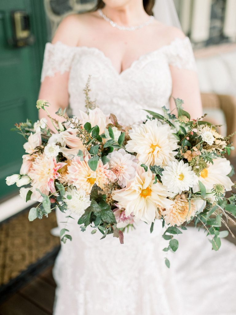 Inn at Grace Winery Wedding | Philadelphia | Autumn bridal bouquet full of cream and white dahlias with lots of textural greenery and eucalyptus in a loose natural shape | Flowers by Love 'n Fresh Flowers | Photo by Hillary Muelleck