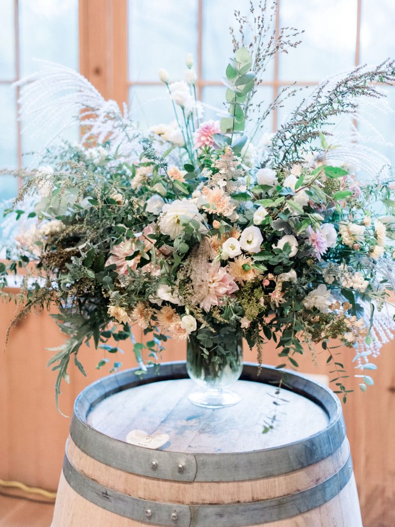Inn at Grace Winery Wedding | Philadelphia | Large overflowing ceremony urn featuring autumn seasonal flowers, including dahlias, lisianthus, heriloom mums and lots of grasses and foraged greenery | Flowers by Love 'n Fresh Flowers | Photo by Hillary Muelleck