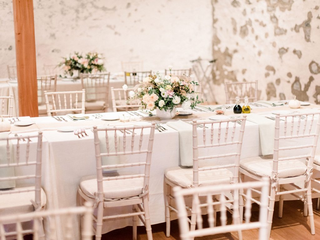 Inn at Grace Winery Wedding | Philadelphia | Long tables at the reception were dressed in white linens with white chiavari chairs with white and green flowers | Flowers by Love 'n Fresh Flowers | Photo by Hillary Muelleck