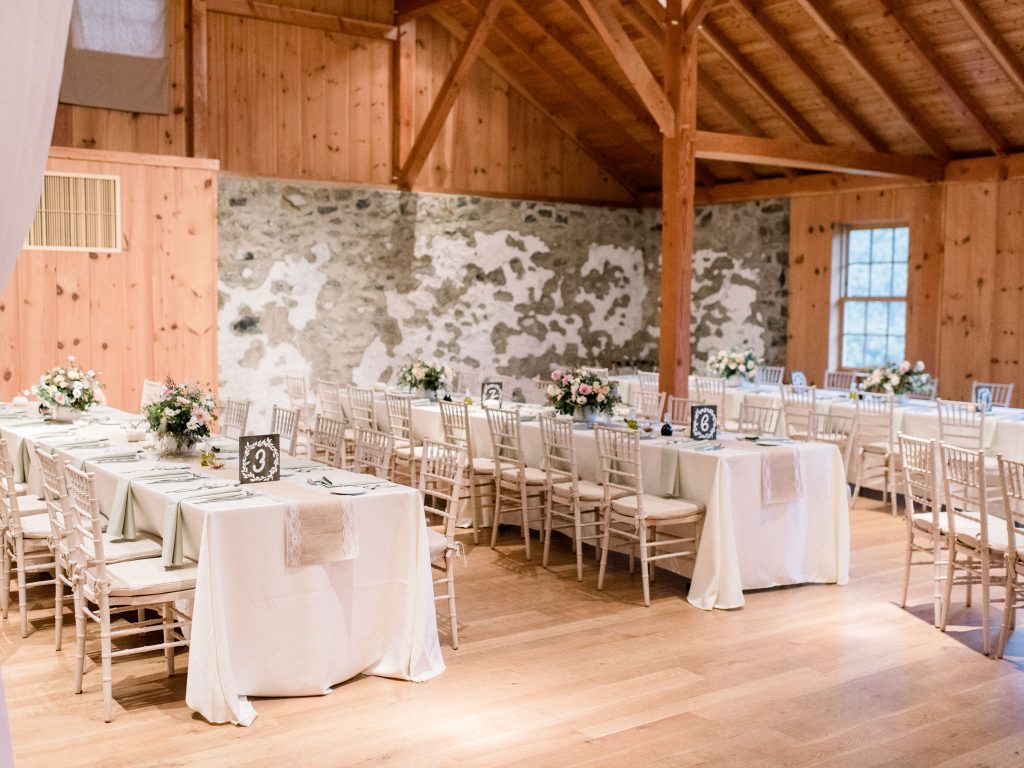 Inn at Grace Winery Wedding | Philadelphia | Long dinner tables at the reception in the barn | Flowers by Love 'n Fresh Flowers | Photo by Hillary Muelleck