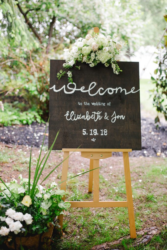 Spring Backyard Wedding | Philadelphia | Wooden wedding welcome sign with flowers | Florals by Love 'n Fresh Flowers | Photo by Asya Photography