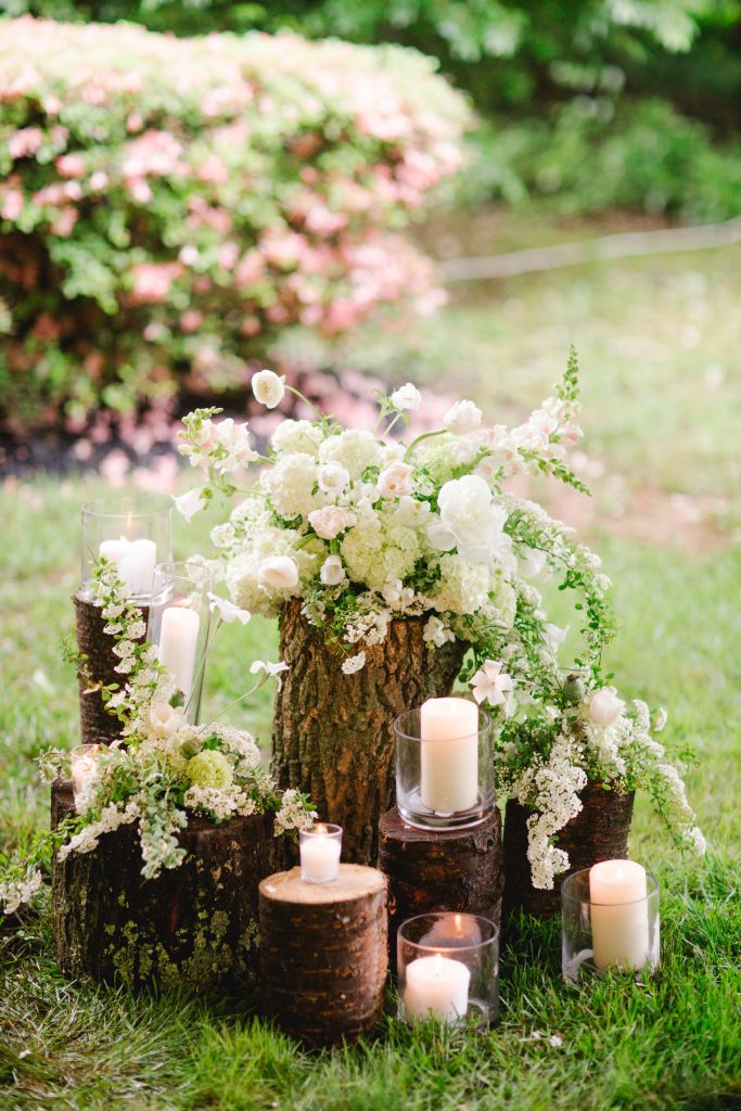 Spring Backyard Wedding | Philadelphia | Stumps with flowers and candles at wedding ceremony | Florals by Love 'n Fresh Flowers | Photo by Asya Photography