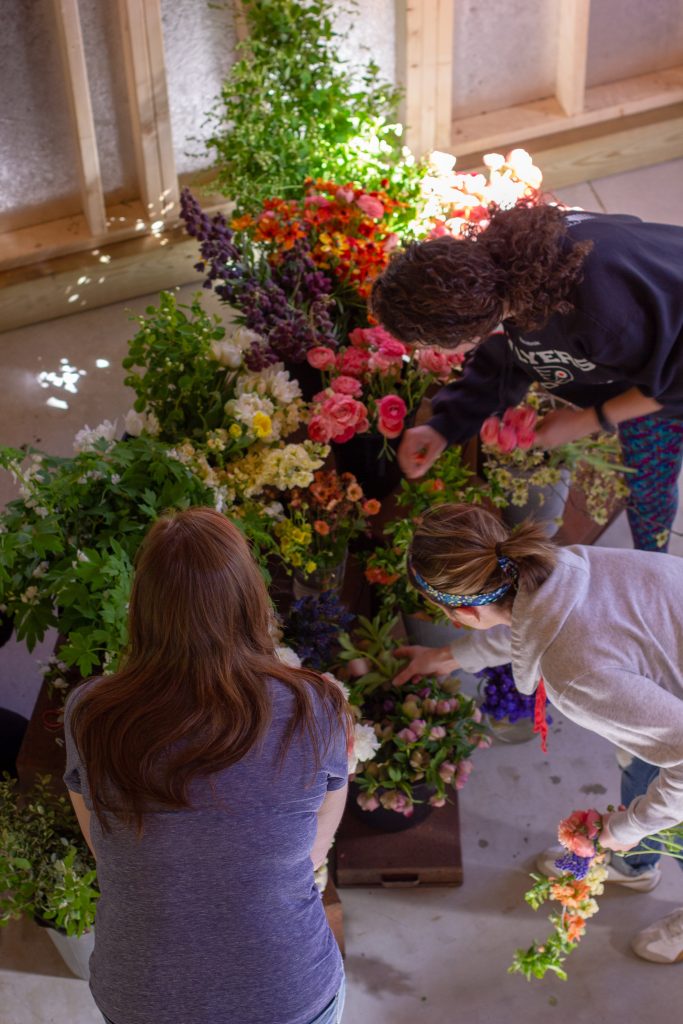 Students gathering their choice of blooms during the Floral Jewelry Floral Design Workshop at Love 'n Fresh Flowers in Philadelphia | Photo by Love 'n Fresh Flowers
