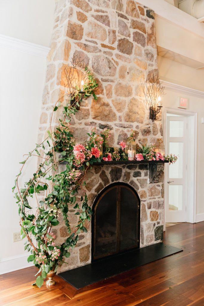 Colorful summer wedding inspiration at Pomme in Radnor | Fireplace with fresh flowers at wedding. Flowers by Love 'n Fresh Flowers | Photo by Emily Wren Photography