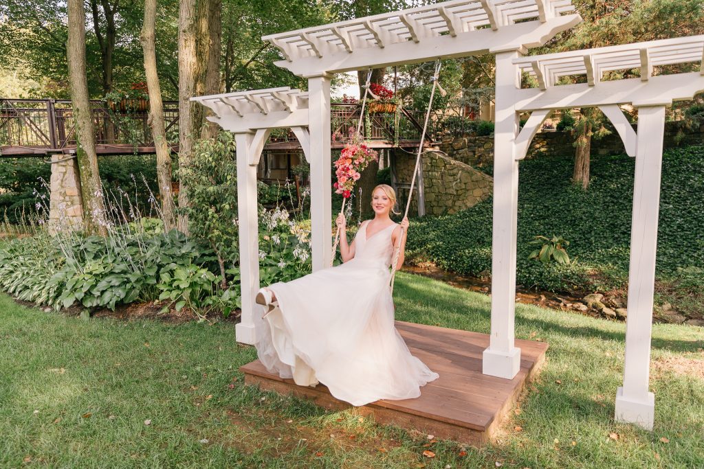 Colorful summer wedding inspiration at Pomme in Radnor | Bride on Swing | Flowers by Love 'n Fresh Flowers | Photo by Emily Wren Photography