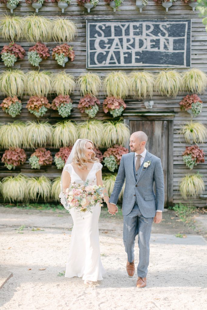 Couple Enjoying a Stroll at This Intimate Wedding at Terrain at Styers | Photo by Grace and Ardor | Flowers by Love 'n Fresh Flowers